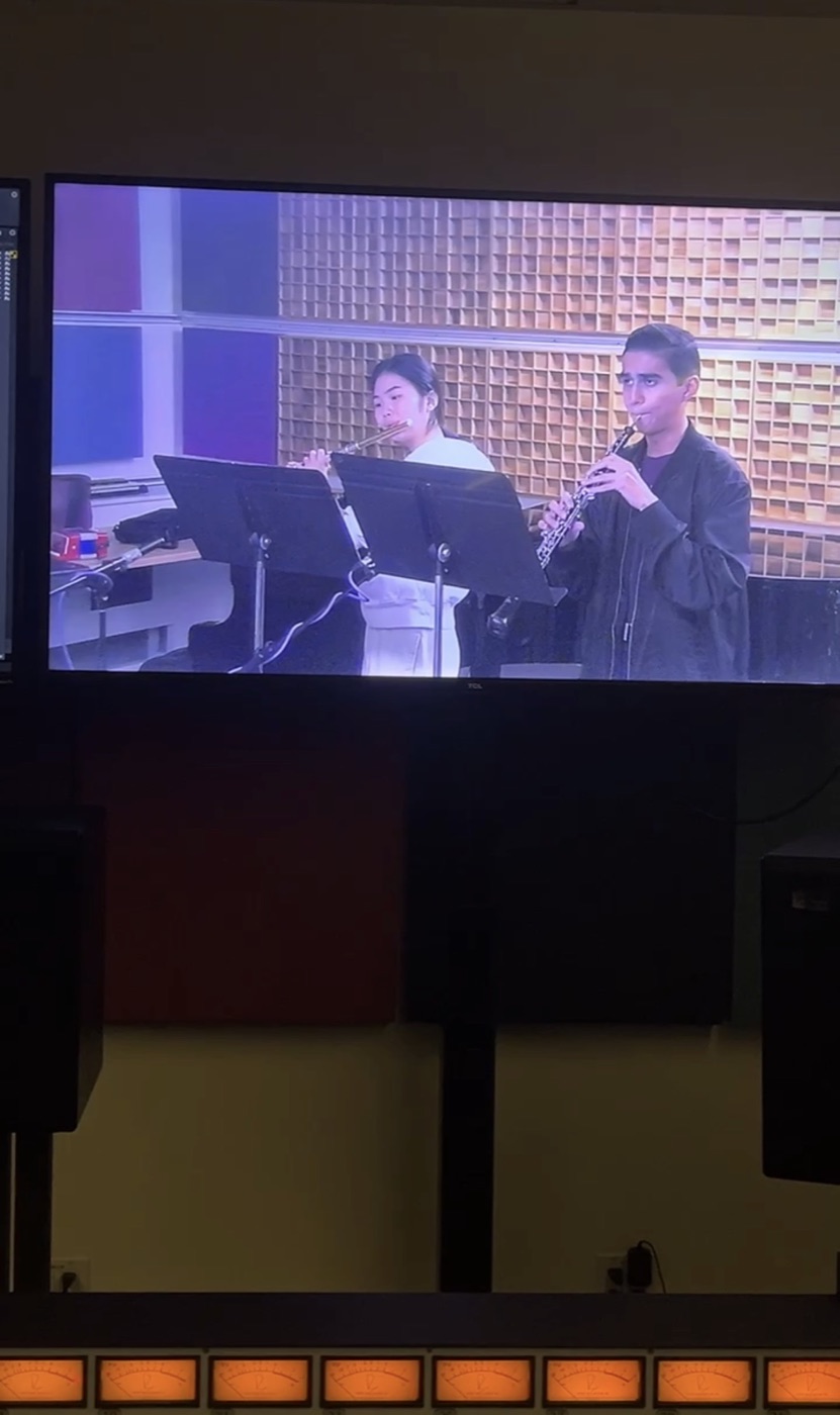 Flute and oboe performers viewed from the recording control room